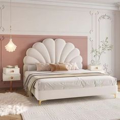 a white bed sitting on top of a wooden floor next to a pink headboard