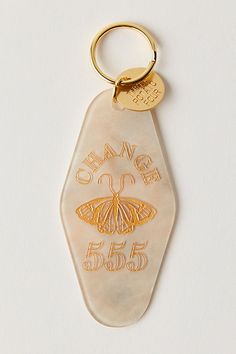 a keychain with a butterfly on it and the words change in gold lettering