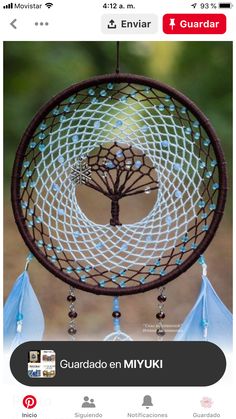 a blue and white dream catcher with a tree on it