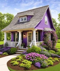 a purple house with flowers around the front yard