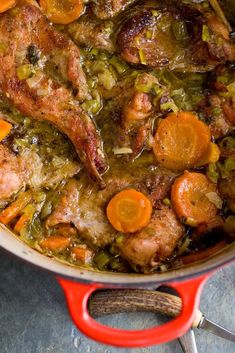 a pot filled with meat and vegetables on top of a table