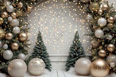 christmas decorations and trees in front of a white wall with gold dots on the background