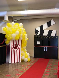 a popcorn box and some balloons on the floor