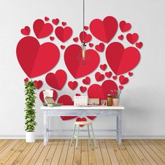 a room with a table and some red hearts cut out of the wall behind it