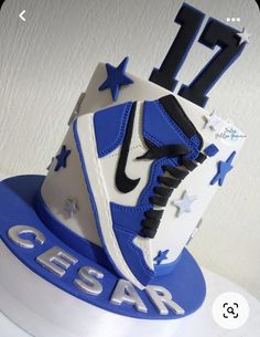 a blue and white nike shoe cake with the number 17 on it's side