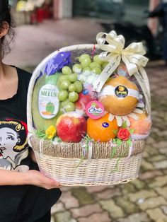 a woman holding a basket full of fruit