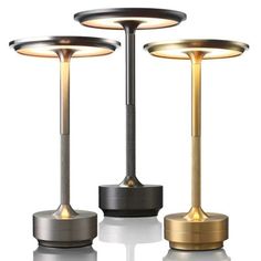 three different types of lamps are shown on a white surface, one is gold and the other is black