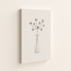 a black and white drawing of a flower in a glass vase on a wall mounted canvas