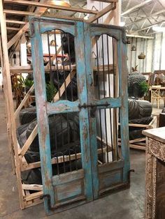 an old blue door is open in a shop