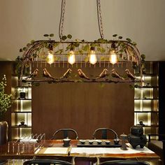 a chandelier hanging over a dining room table with chairs and plants on it