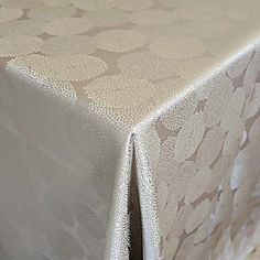 a white table cloth with an intricate design on it's edges and bottom edge