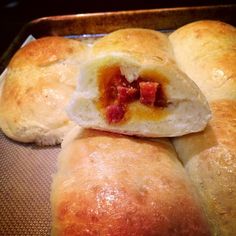 some bread rolls are sitting on a baking pan