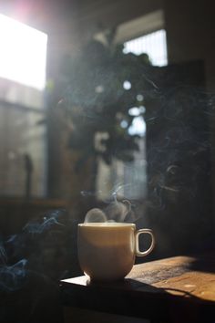 a coffee cup sitting on top of a wooden table