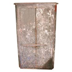 an old metal cabinet with rusted paint on it