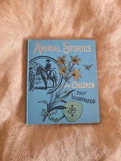 an old children's book is laying on a bed with the title animal stories for children fully illustrated