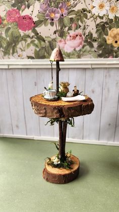 Welcome to Sarah's Little Cottage! This fairy table is handmade with real 1 - 3 inch wood slices, apple tree twigs, and moss.  The table features a white teacup on a white plate, a stack of papers, a clay mushroom lamp, a succulent in a little round planter, two white candles, a real mini quartz cluster, and a little brass bowl with a wooden stick to look like palo santo. The mushroom lamp is hand made with an apple tree twig and a hand molded clay mushroom top. The mushroom top is hand painted Fairy Nook, Diy Fairy Garden Accessories, Mini Garden Decor, Fairy Items, Miniature Garden Decor, Diy Fairy Door, Fairy Garden Miniatures, Twig Furniture, Clay Mushroom