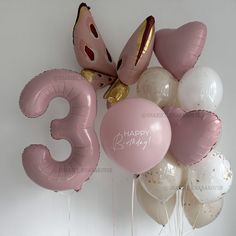 balloons and heliums are arranged in the shape of numbers