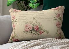 a white couch with a pillow on top of it next to a potted plant