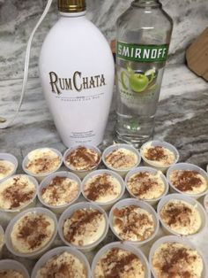 a bottle of rumchata next to some cupcakes on a marble counter