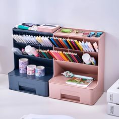 a pink desk organizer with pencils, pens and other office supplies