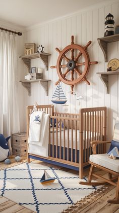 a baby's room with a ship wheel and sailboat decor on the wall