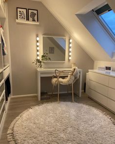 a room with a white rug and some lights on the ceiling, along with a chair