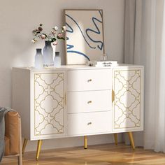 a white and gold cabinet with flowers on top