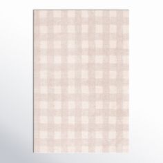 a beige and white checkered towel hanging on a wall