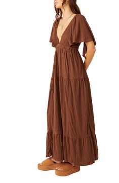 Easy and enchanting, this breezy plunge-neck maxi features fluttering sleeves and a flouncy tiered skirt. 57" length (size Medium) Plunge neck Elbow-length sleeves 65% polyester, 34% viscose, 1% elastane Machine wash, tumble dry Imported Flowy Long Sleeve Brown Midi Dress, Flowy Long Sleeve Brown Maxi Dress, Brown Bohemian Floor-length Maxi Dress, Free People Gum Drop Dress Brown, Brown Bohemian V-neck Maxi Dress, Maxi Dress Online, Tier Skirt, Elbow Length Sleeve, Maxi Dress With Sleeves