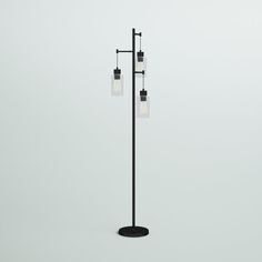 a black lamp with three lights hanging from it's sides on a white background