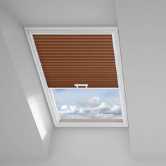 a room with a skylight and brown blinds