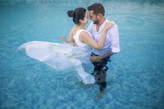 a man and woman in the water holding each other