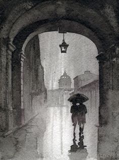 a person holding an umbrella in the rain under a street light on a rainy day