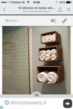 three baskets are hanging on the wall above a toilet