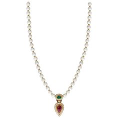 A Cultured Pearl Necklace with an Oval Emerald Cabochon, a Pear-Shape Ruby Cabochon, and Diamonds on the pendant and on the clasp as well. Each bead has a gold spacer in between. The length of the entire necklace from the clasp to the bottom of the ruby pendant is 22 Inches. Total Weight: 48.35 grams. Luxury Oval Cabochon Necklace With Natural Stones, Luxury Heirloom Necklace With Cabochon, Emerald Cabochon, Cultured Pearl Necklace, Ruby Pendant, Cultured Pearls, Pear Shape, Pear Shaped, Antique Vintage