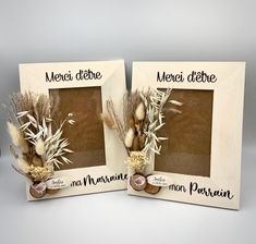 two frames with flowers and leaves on them are sitting side by side in front of each other