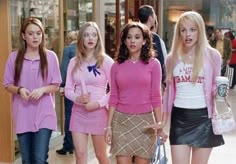 the mean girls are walking down the street together in pink sweaters and skirts,