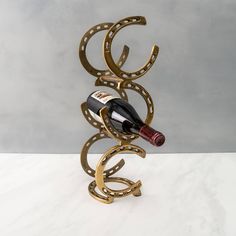 a wine bottle holder made out of metal