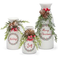 three white vases with christmas decorations on them