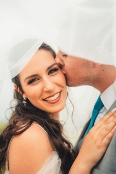 Glam bridal makeup on a happy bride with her groom kissing her on the cheek Glam Makeup, Real Brides