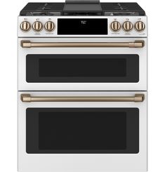 two white and gold ovens side by side with the same oven on each side