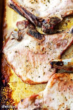 grilled pork chops on a baking sheet