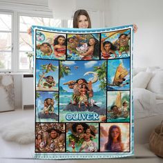 a woman holding up a blanket with pictures of people on it