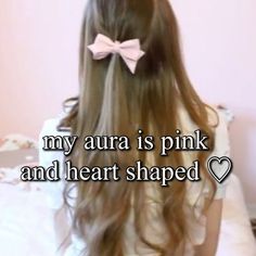 a girl with long hair wearing a pink bow