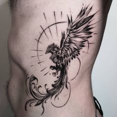 a man's stomach with a bird tattoo on it