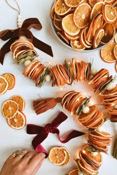 orange slices are arranged on a table with ribbons and tassels to decorate them