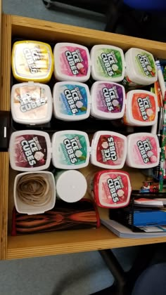 a drawer filled with lots of different types of ice creams and other condiments