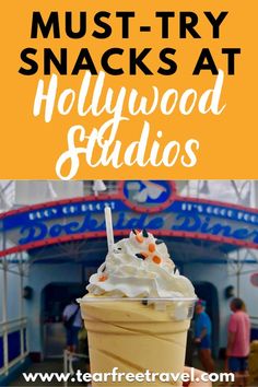 an ice cream sundae with whipped cream and sprinkles on top in front of the hollywood studios sign