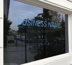 a business name sign is reflected in the window