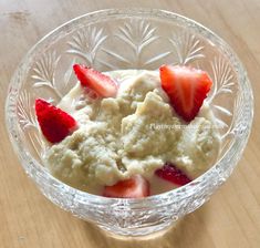 a bowl filled with ice cream and strawberries